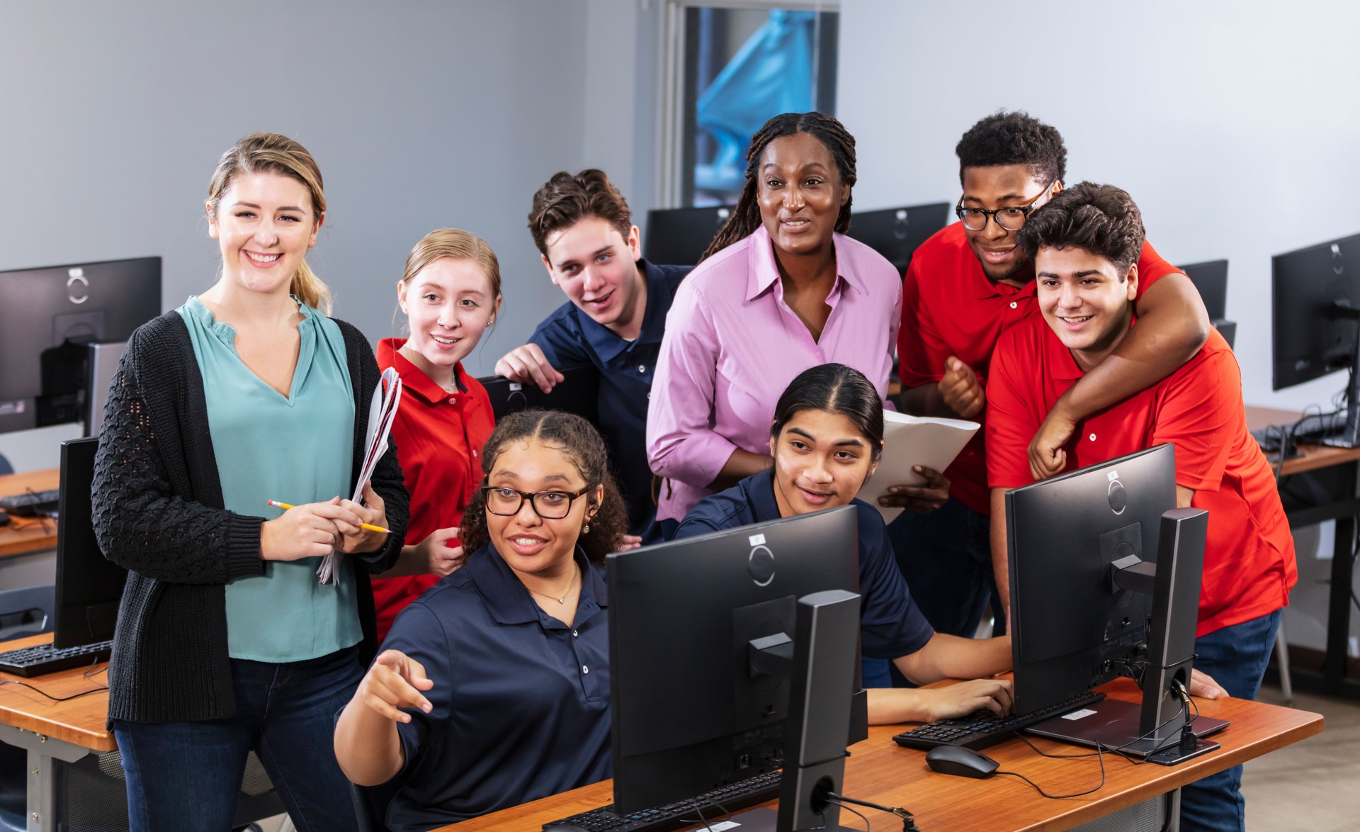 Teachers and high school students in computer class